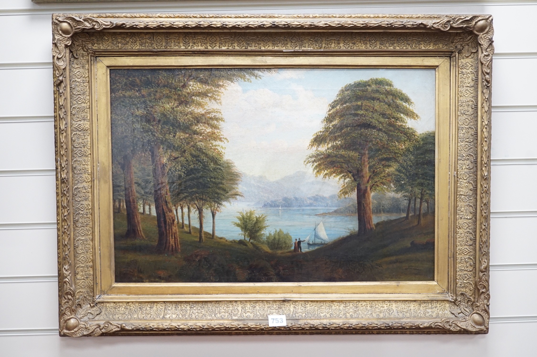 English School c.1900, oil on canvas, Figures and sailing boat beside a lake, 39 x 59cm